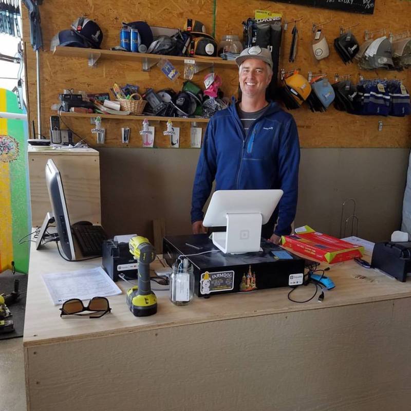 Man at register with surf equipment