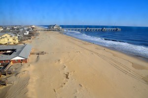 a sandy beach next to the ocean