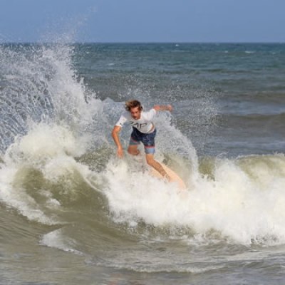 a man riding a wave on a surfboard in the water