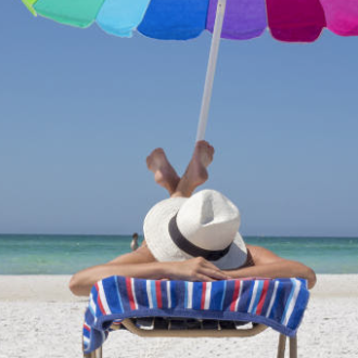 an umbrella sitting on top of a sandy beach