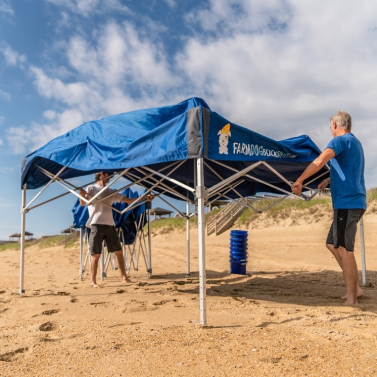Farmdog Beach Services team setting up tent.