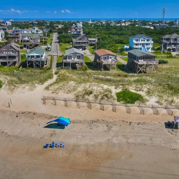 drone shot of Outer Banks beach with a blue tent in the middle