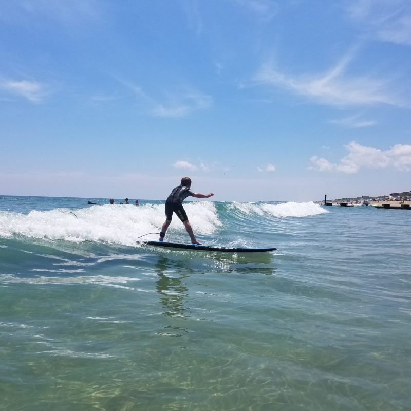 a person riding a surf board on a body of water