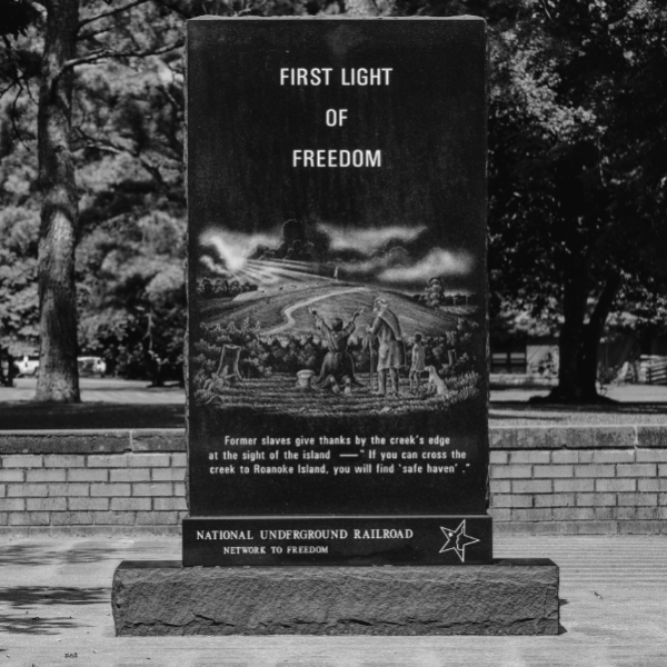 a bench in front of a sign